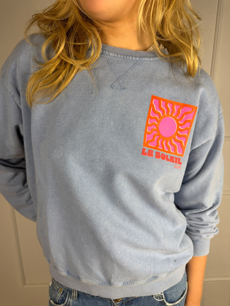 Le Soleil Sweater – Blau/Grau mit pink-orangem Sonnenprint